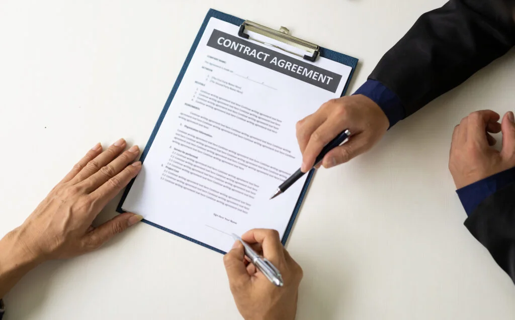 Business people signing a contract agreement. Concept of legal and business agreement signing.